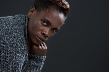 Androgynous man posing with hand on his chin