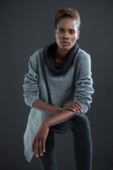 Androgynous man posing against grey background