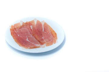  Raw ham prosciutto in a white dish isolated on white background