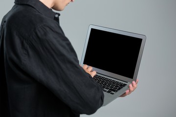 Androgynous man using laptop