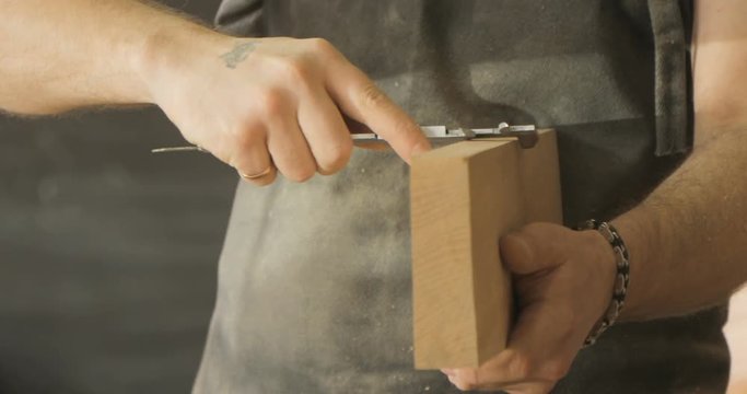 carpenter checks the quality of the wooden board