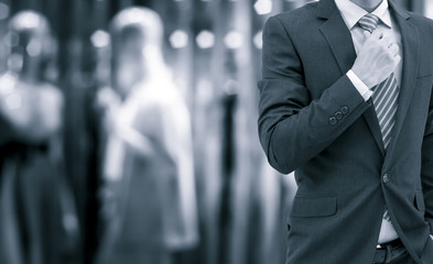 isolated business man on shopping mall background on blue tone