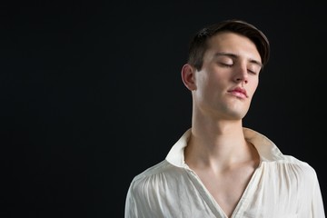 Androgynous man posing with his eyes closed