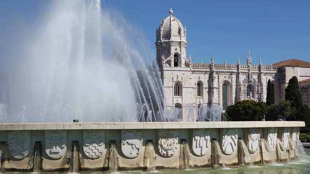 Fountain named Luminosa and Gardens in front of Monastery named Jeronimos in Belem district. Lisbon, Portugal
