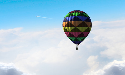 Aerostat flying above clouds . Mixed media