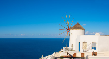  Traditional windmill and apartments in Oia village, Santorini, Greece