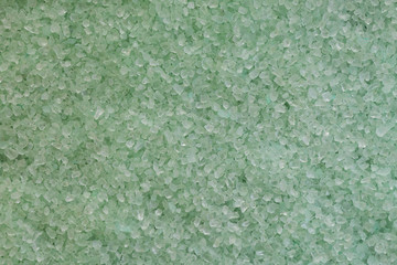 Background with mint green sea salt, closeup