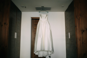 The bride's dress on a hanger in the room in Montenegro