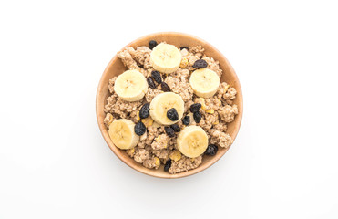 granola with banana, raisin and milk for breakfast