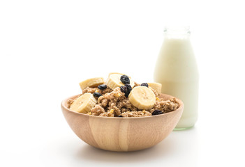 granola with banana, raisin and milk for breakfast