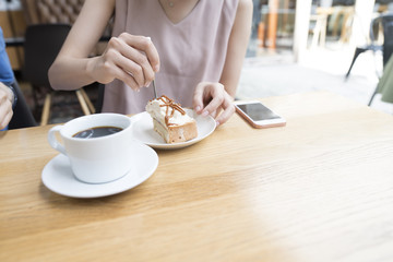 Women are eating coffee and cakes at a cafe