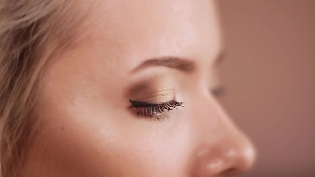 Eye makeup woman applying eyeshadow powder