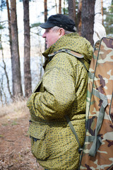 Mature caucasian man with backpack in the forest