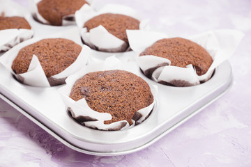 Chocolate muffins on the rustic background. Selective focus.