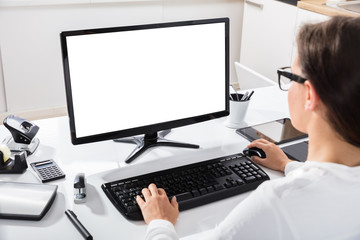 Businesswoman Using Computer At Workplace