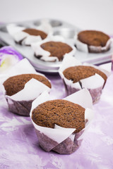 Chocolate muffins on the rustic background. Selective focus.