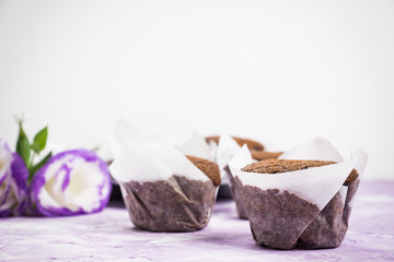Chocolate muffins on the rustic background. Selective focus.