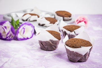 Chocolate muffins on the rustic background. Selective focus.
