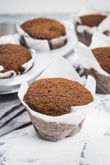 Chocolate muffins on the rustic background. Selective focus.