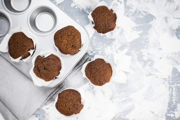 Chocolate muffins on the rustic background. Selective focus.