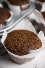 Chocolate muffins on the rustic background. Selective focus.