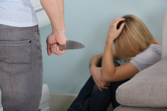 Man Holding Knife In Front Of A Frighten Woman