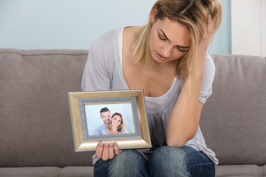 Unhappy Woman Holding Picture Frame