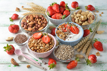 Muesli, nuts, yogurt and cereals on a white background