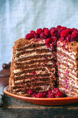 Close up of high delicious chocolate honey cake with nuts and cream cheese garnished with crumble...
