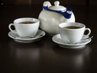 Two white cups with tea