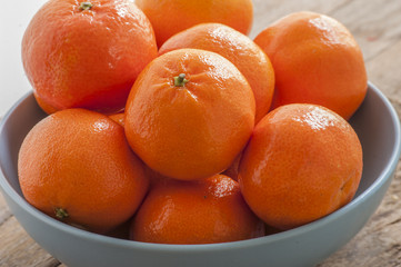 Fresh mandarins on a wooden board.