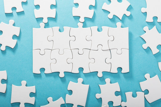 White Jigsaw Puzzles On Blue Background