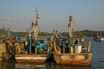 Fototapeta na wymiar CHAPORA, GOA, INDIA - MARCH 3, 2017: Fishing boats on Chapora port in Goa, India on March 3, 2017