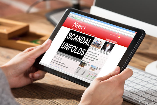 Woman Reading Scandal News On Digital Tablet