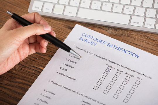 Businesswoman Filling The Customer Satisfaction Survey Form