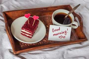 Breakfast in bed. Cup, coffee, red, velvet, cake and note with text Good morning