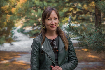 Young beautiful woman outdoors in a pine forest