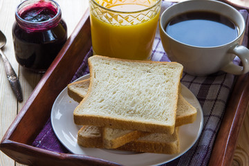 Breakfast: blueberrу jam, toast, coffee and orange juice