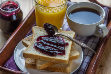 Breakfast: blueberrу jam, toast, coffee and orange juice