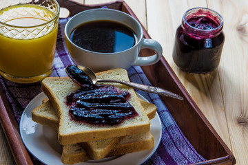 Breakfast: blueberrу jam, toast, coffee and orange juice