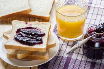 Breakfast: blueberrу jam, toast, coffee and orange juice