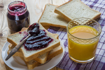 Breakfast: blueberrу jam, toast, coffee and orange juice
