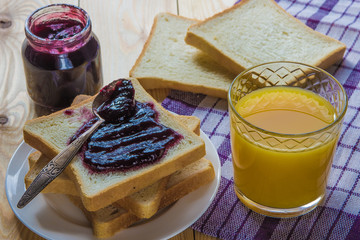 Breakfast: blueberrу jam, toast, coffee and orange juice