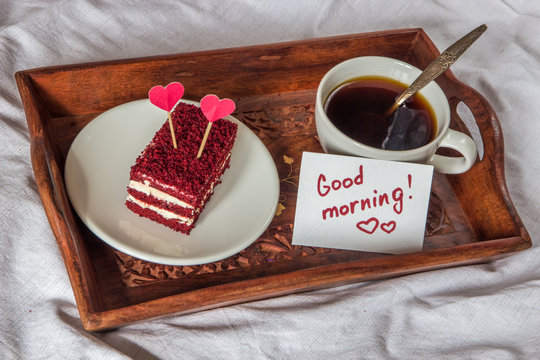 Breakfast in bed. Cup, coffee, red, velvet, cake and note with text Good morning