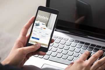Person Booking Hotels Using Cell Phone