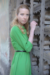 Blonde girl in lace dress in an old fortress
