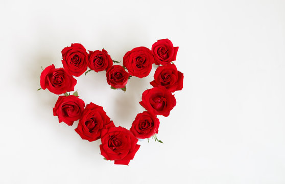 Heart Shaped Red Rose Arrangement on a White Background