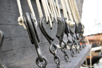 Ancient wooden sailboat pulleys and ropes detail