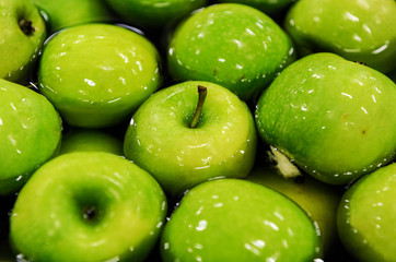 Green delicious apples in packing tub at fruit warehouse