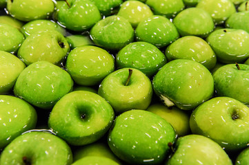 Green delicious apples in packing tub at fruit warehouse